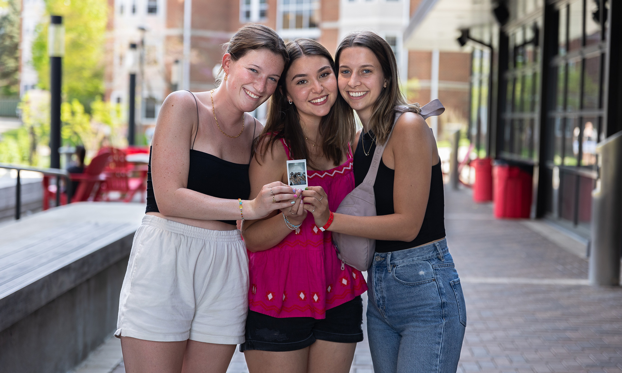 Quinn Wagner (middle) and two of her friends with a photo they retrieved from their time capsule.