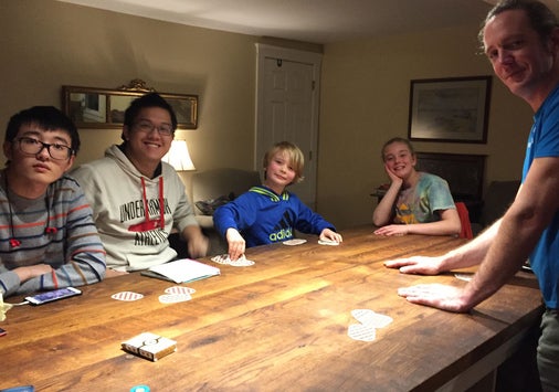 Henshaw family and students playing board game