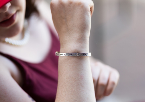 A silver bracelet, inscribed with the quote “She believed she could, so she did”