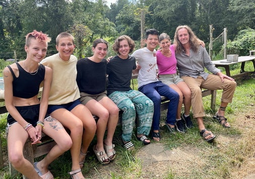 A group of people sitting outside at the homestead