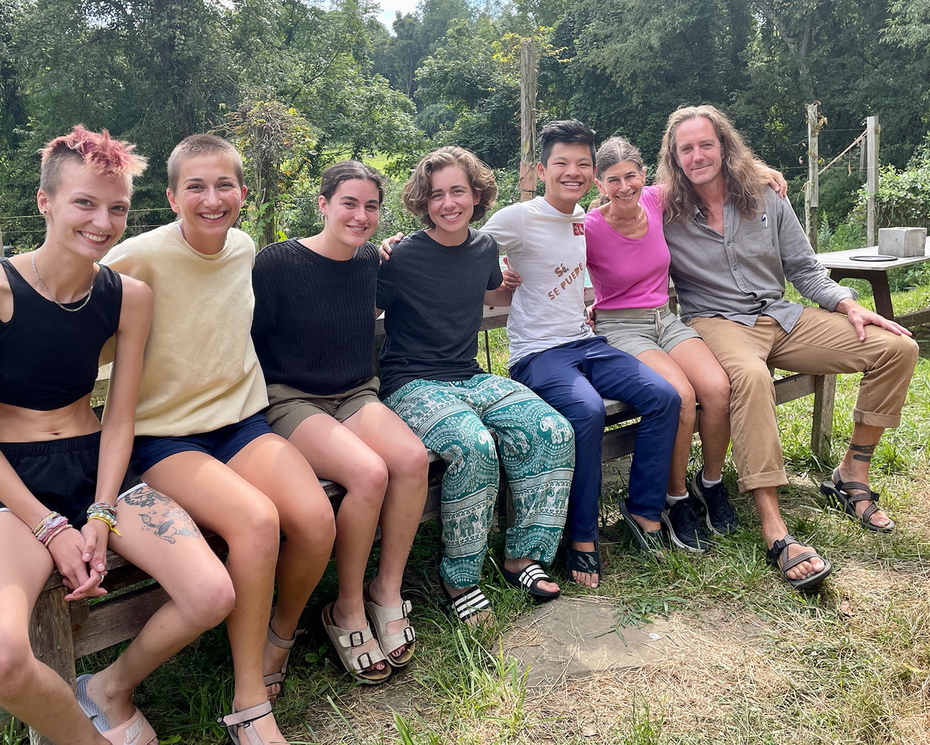 A group of people sitting outside at the homestead