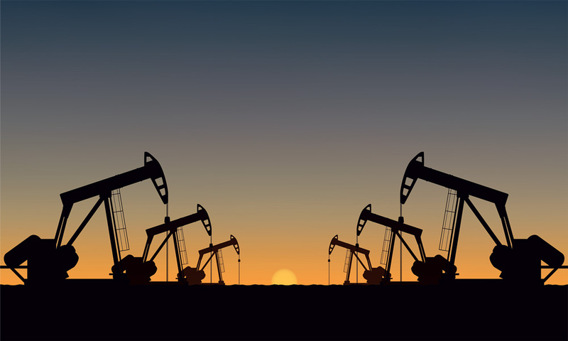 Silhouette Oil pumps at oil field with sunset sky background.