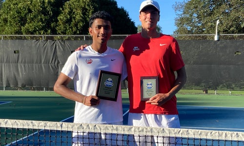 Photo of Kael Shah ’26 and Ethan Green ’26 standing on a tennis court by the net, holding plaques.